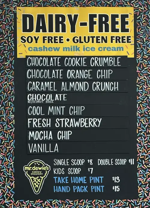Black chalkboard with Mr. Dewie's Dairy Free Flavors and prices