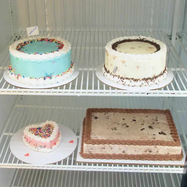 Cooler with four pre-made ice cream cakes in a variety of shapes and flavors